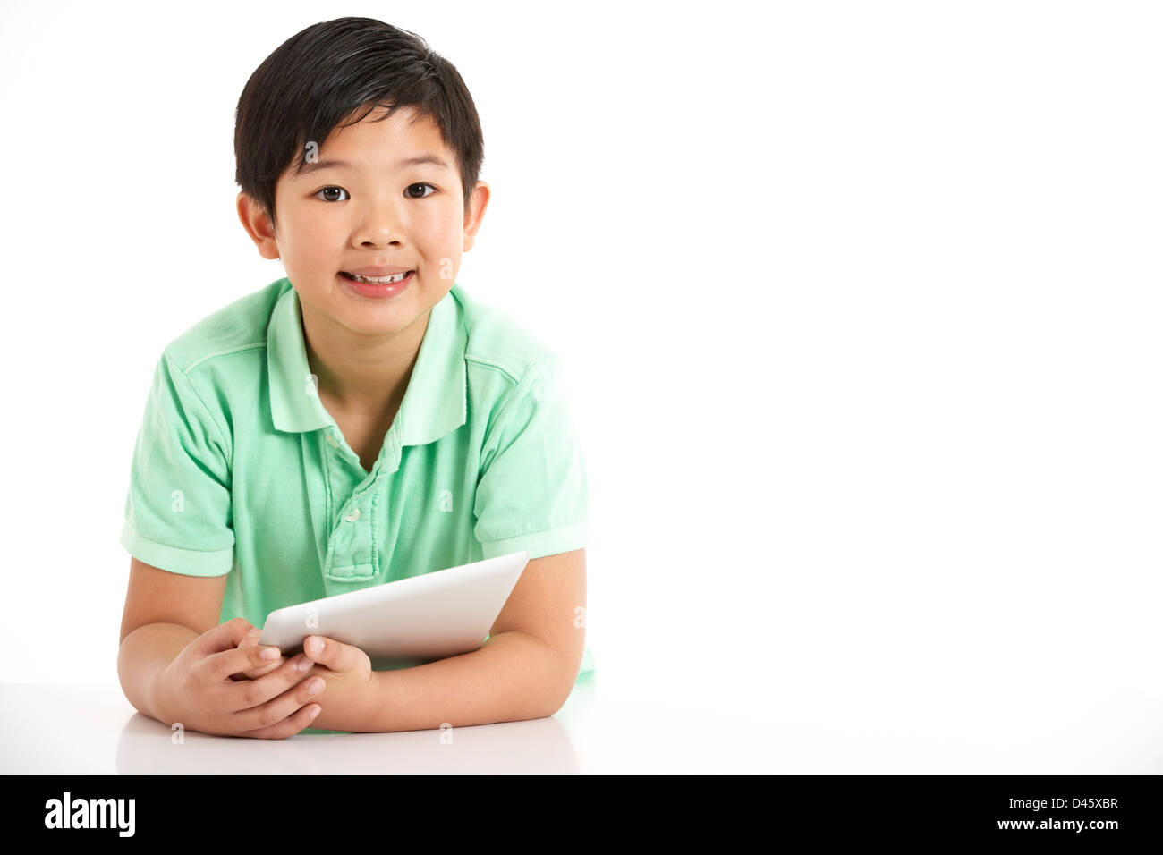 Studio Shot Of Chinese Boy With Digital Tablet Stock Photo