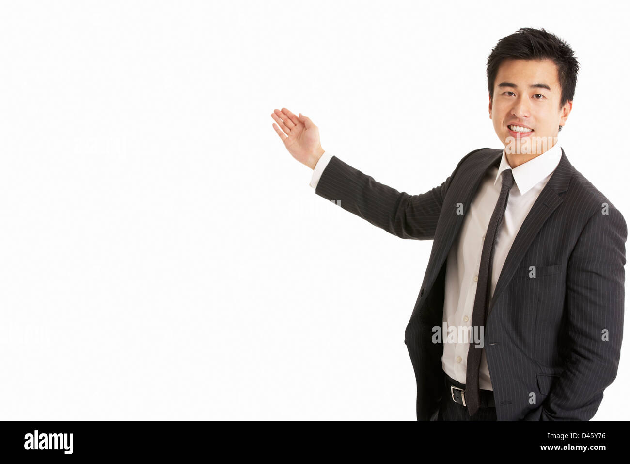 Studio Portrait Of Chinese Businessman Gesturing Stock Photo