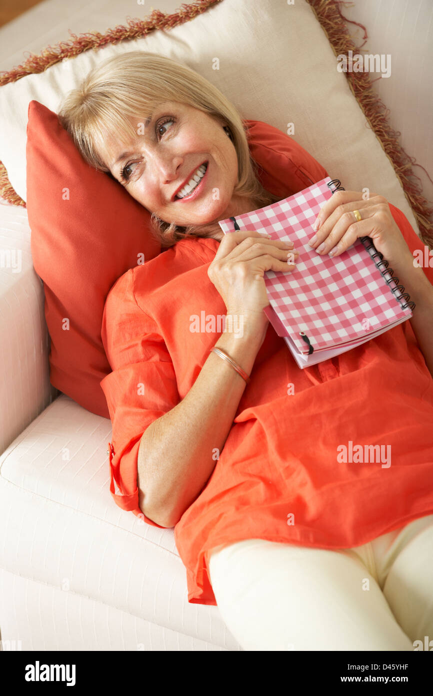 Shocked women sitting on sofa hi-res stock photography and images - Alamy