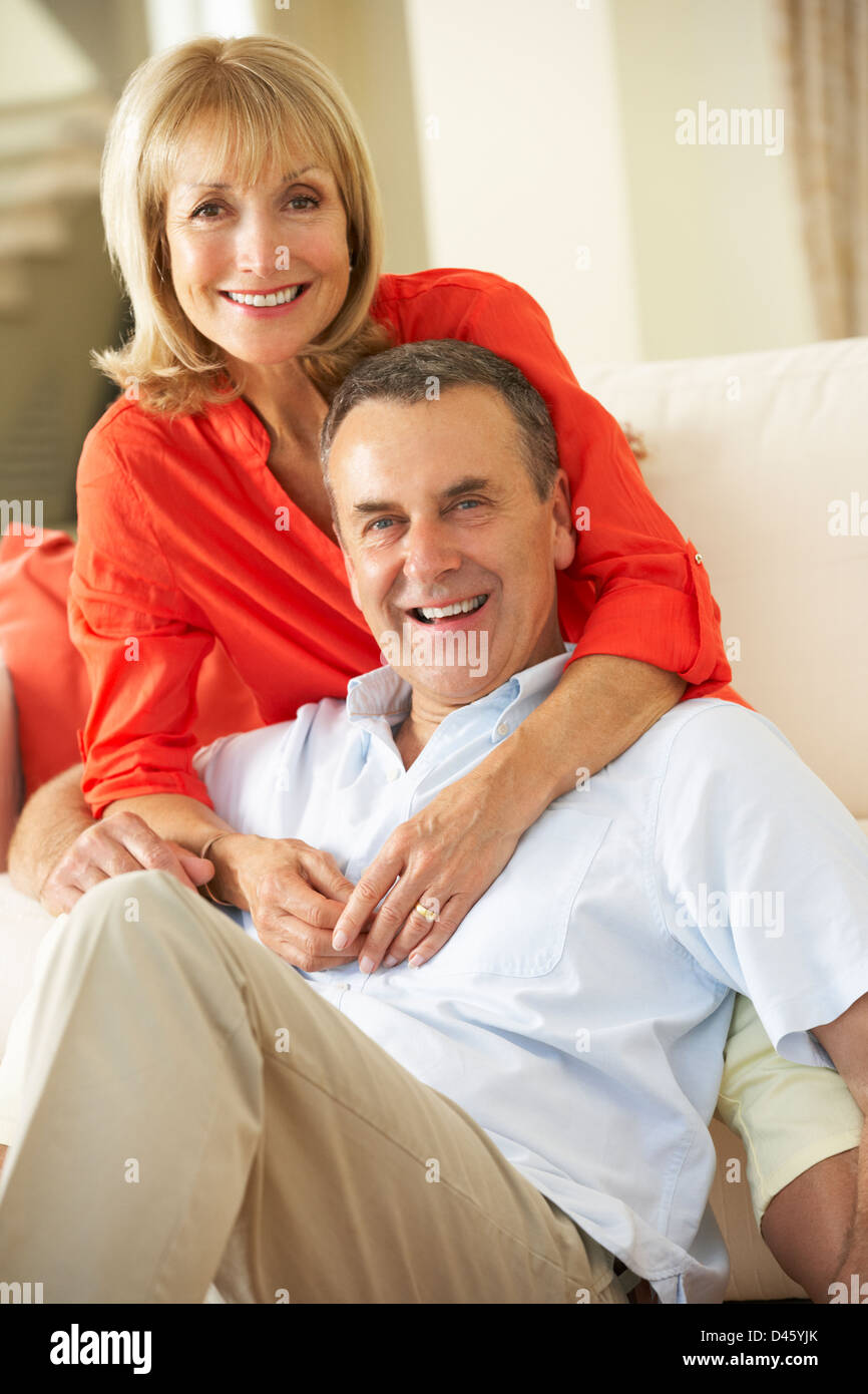 Senior Couple Relaxing On Sofa At Home Stock Photo - Alamy