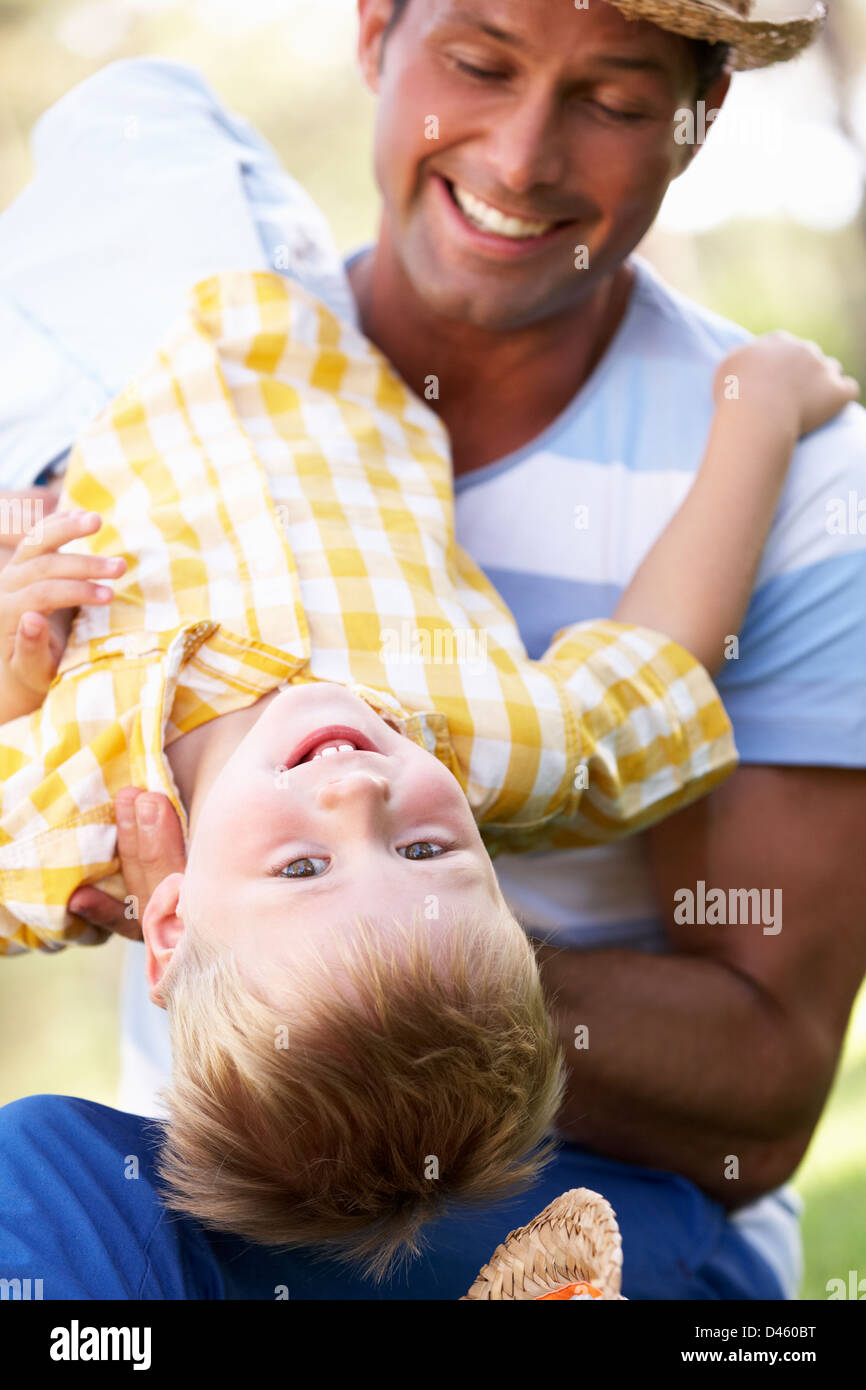Father And Son Playing In Summer Garden Stock Photo