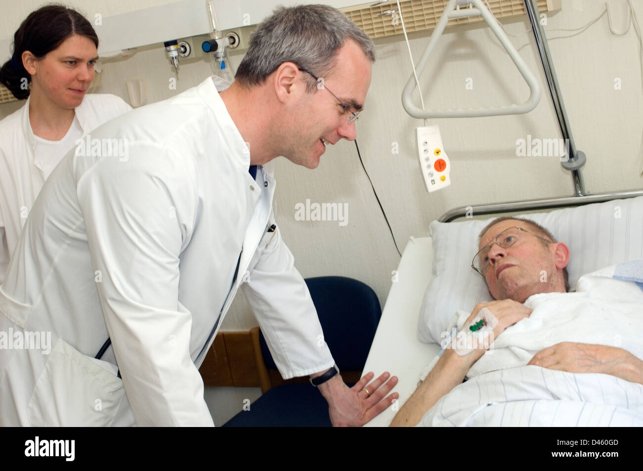 Doctors in an accident and emergency department talking with a man with