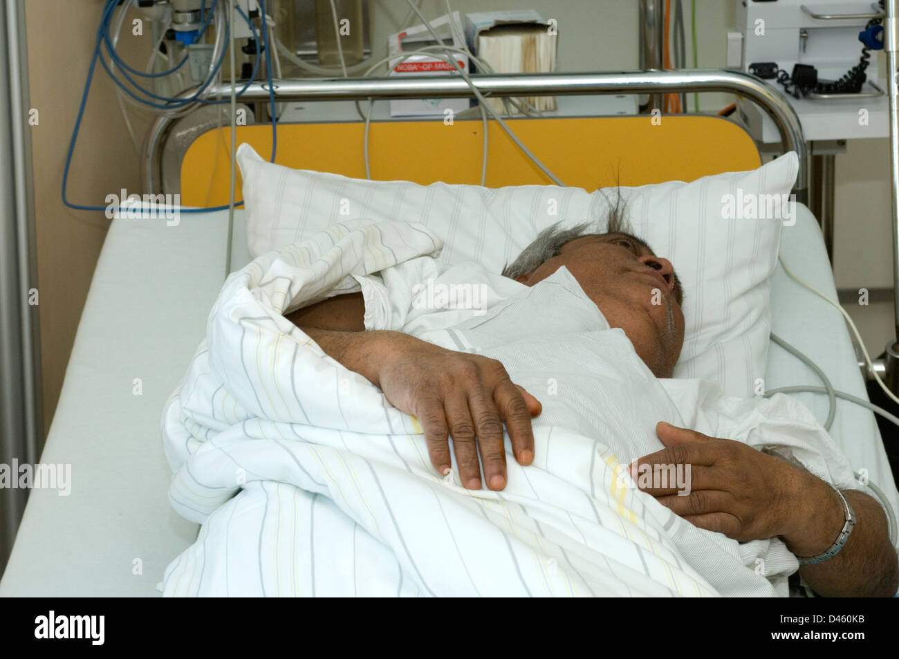 A man resting in a hospital accident and emergency department after being admitted with severe stomach pains. Stock Photo