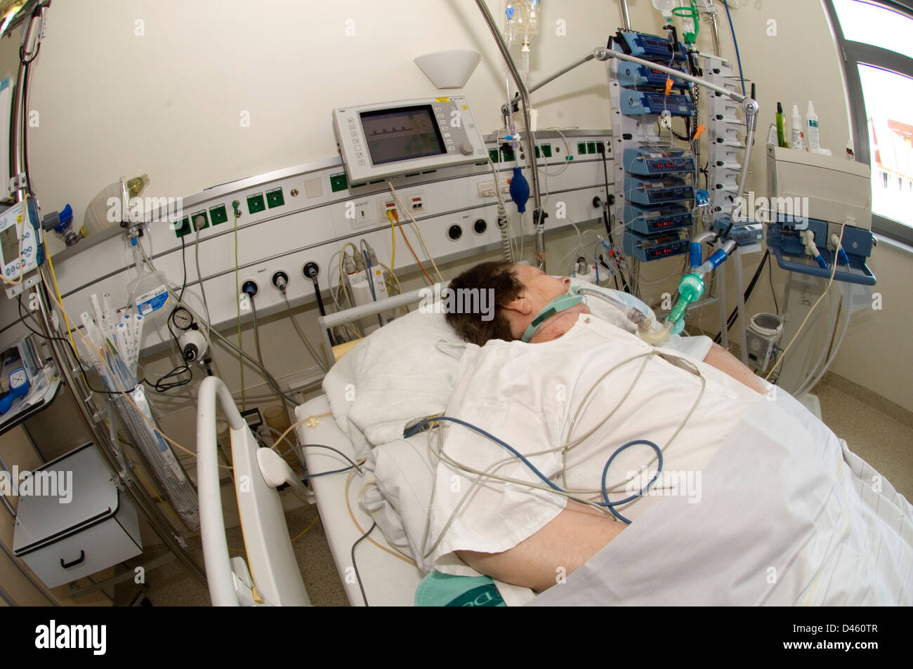 A woman on a life support system in a hospital intensive care unit. Stock Photo