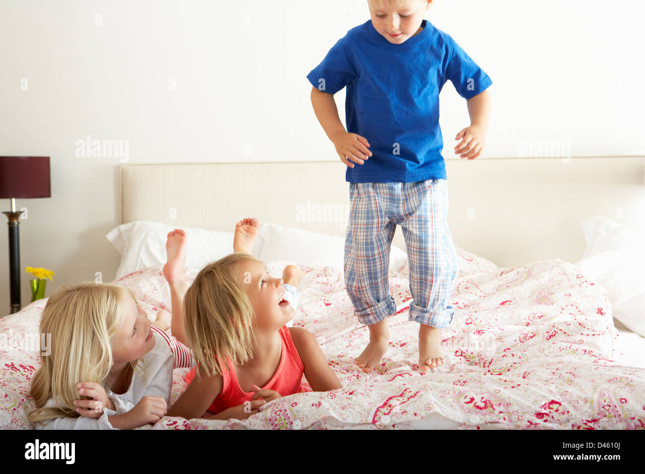 Children Bouncing On Bed Stock Photo