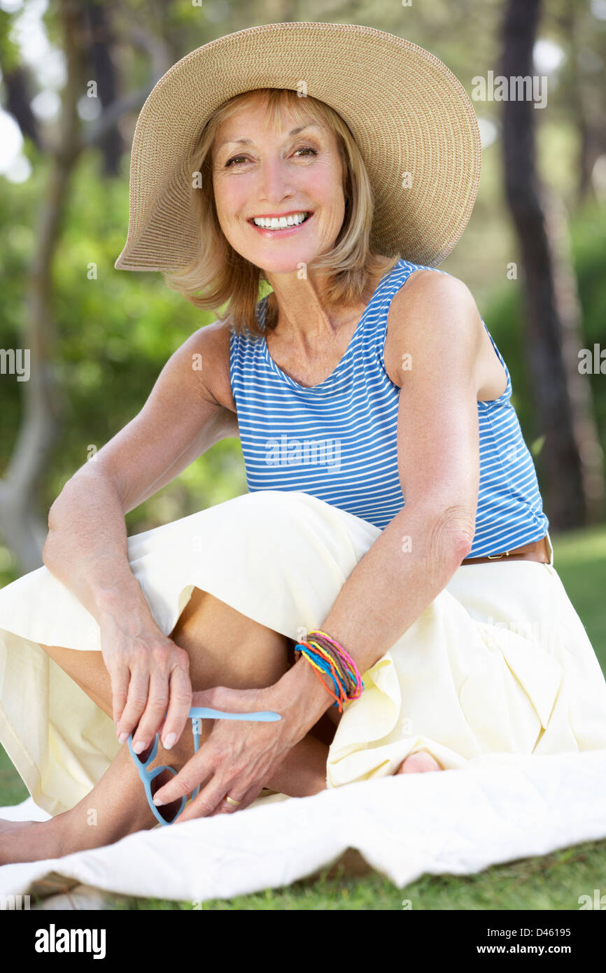 Senior Woman Relaxing In Summer Garden Stock Photo - Alamy