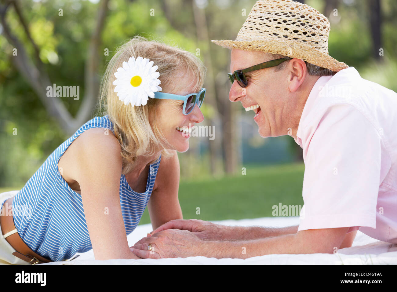Senior Couple Relaxing In Summer Garden Stock Photo - Alamy