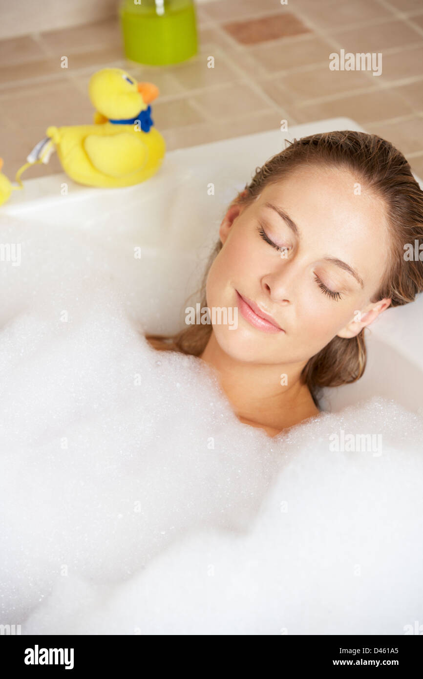 Woman Relaxing In Bubble Filled Bath Stock Photo