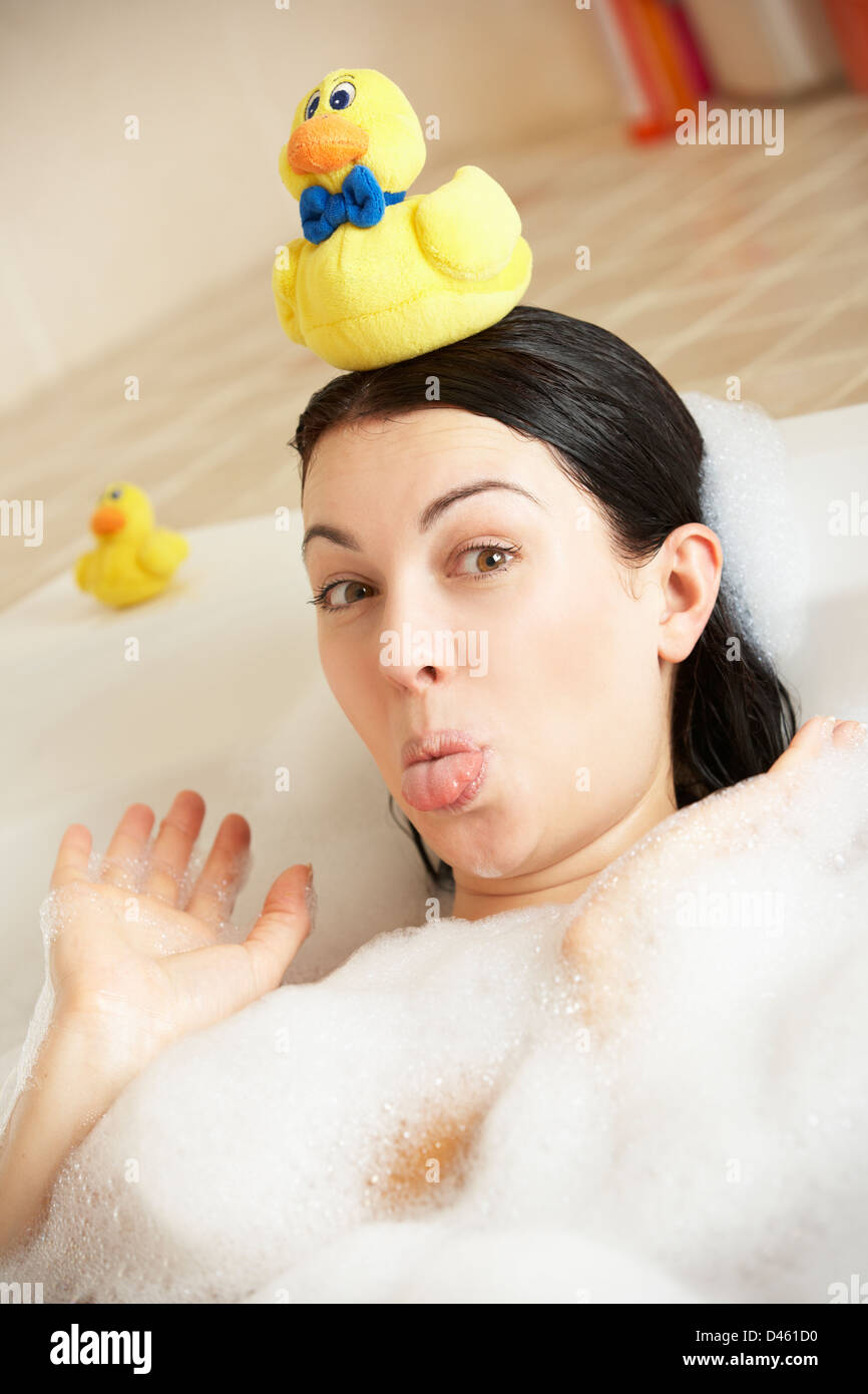 Woman Relaxing In Bubble Filled Bath Stock Photo