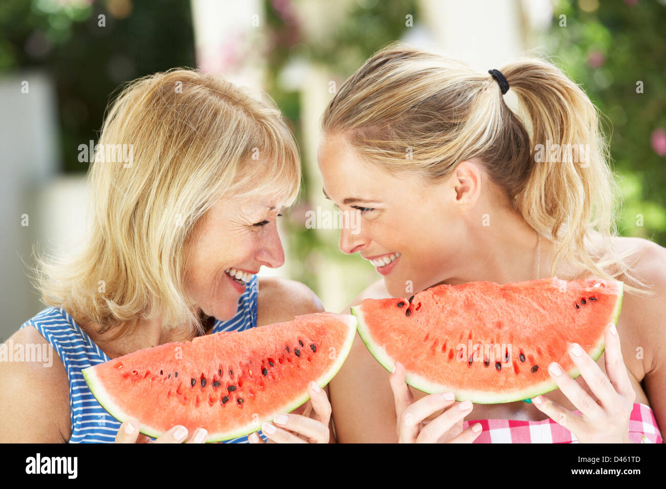 Woman Enjoying Slice Of Water Melon Stock Photo