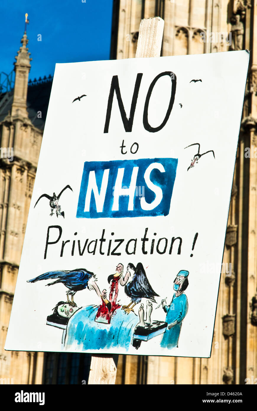 Poster 'No to NHS Privitization' with a picture of vultures eating a body on an operating table, (set against Parliament ). Stock Photo