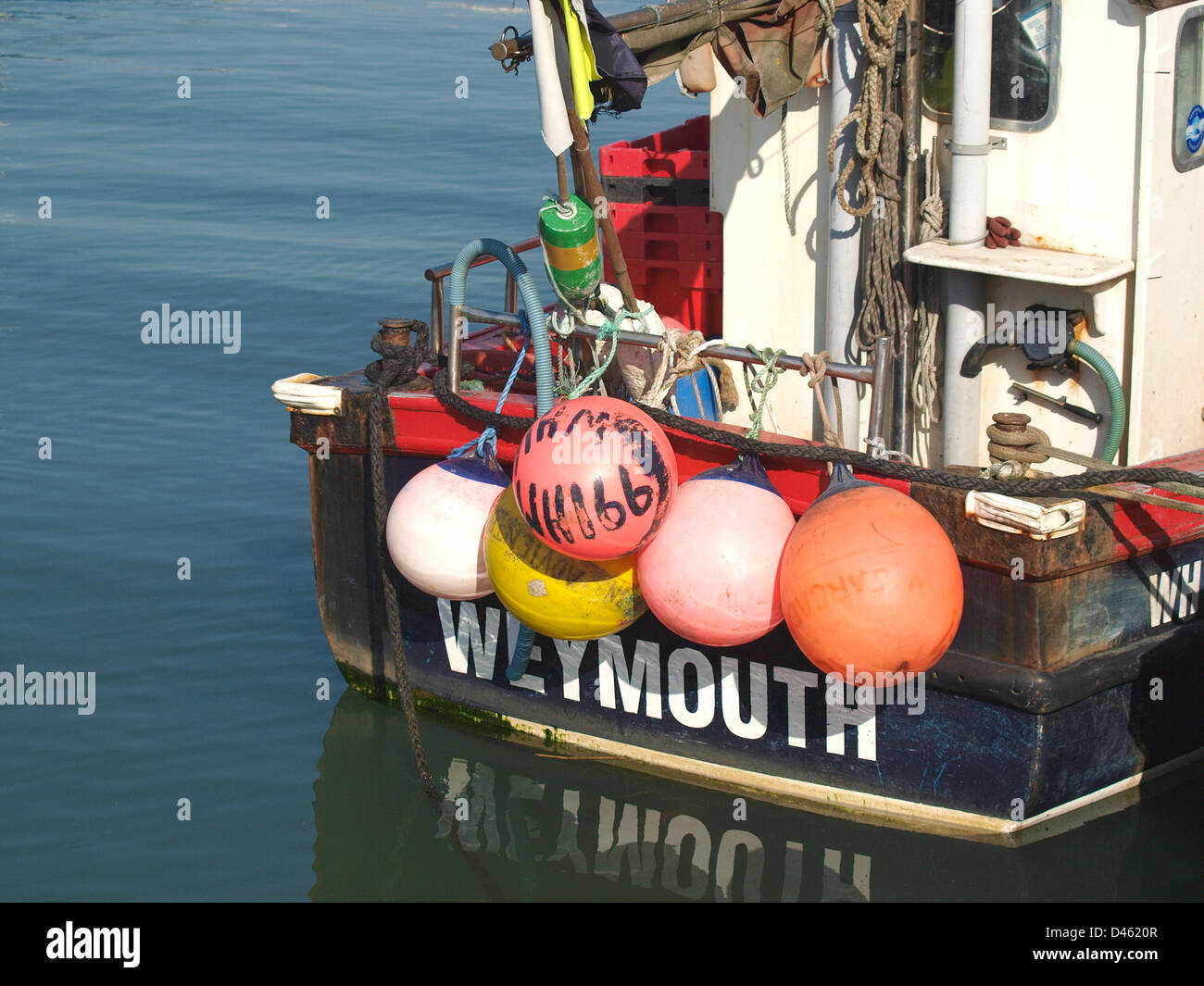 Colourful buoys and fenders on stern of fishing boat Stock Photo Alamy