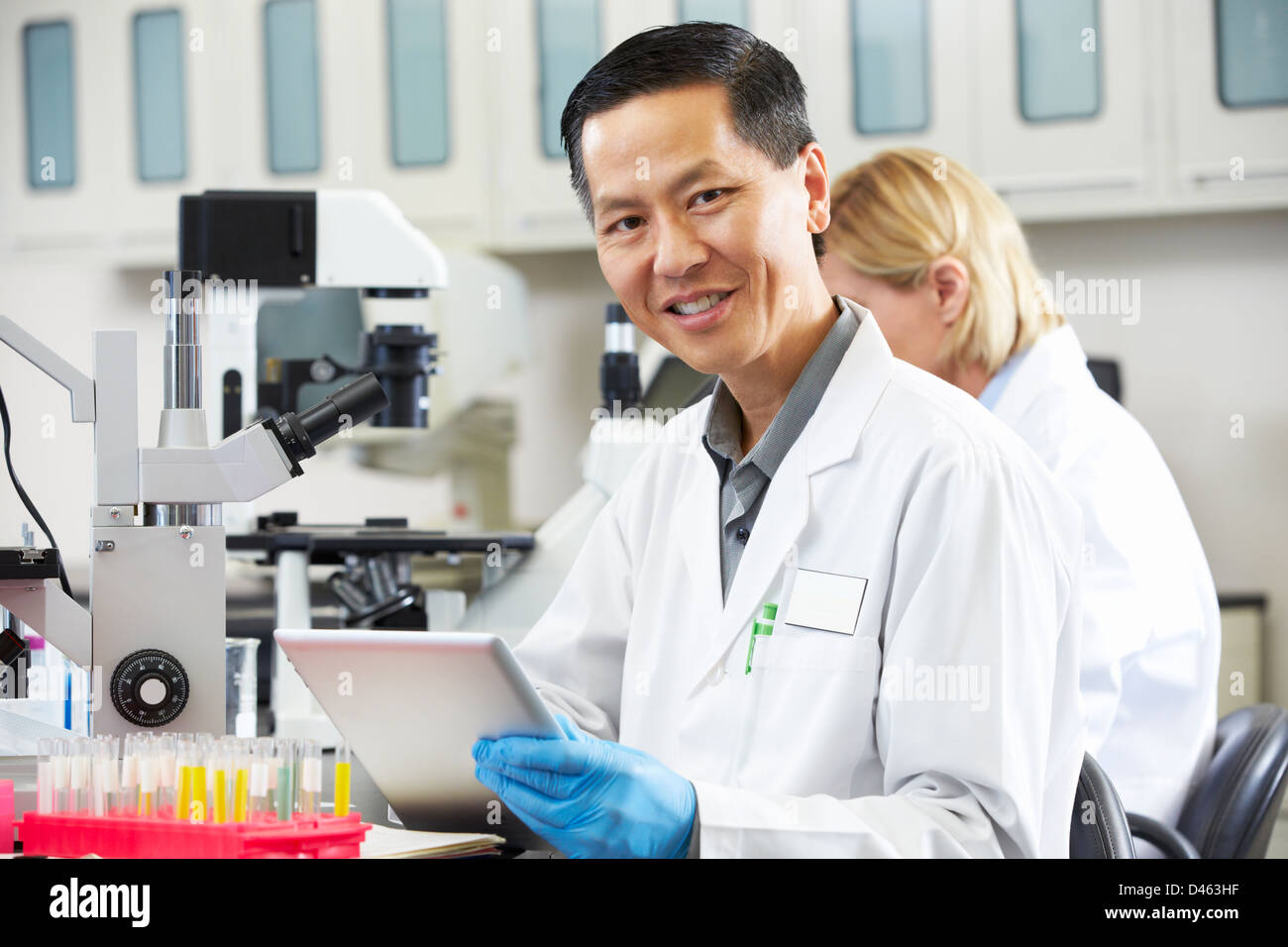 Male Scientist Using Tablet Computer In Laboratory Stock Photo