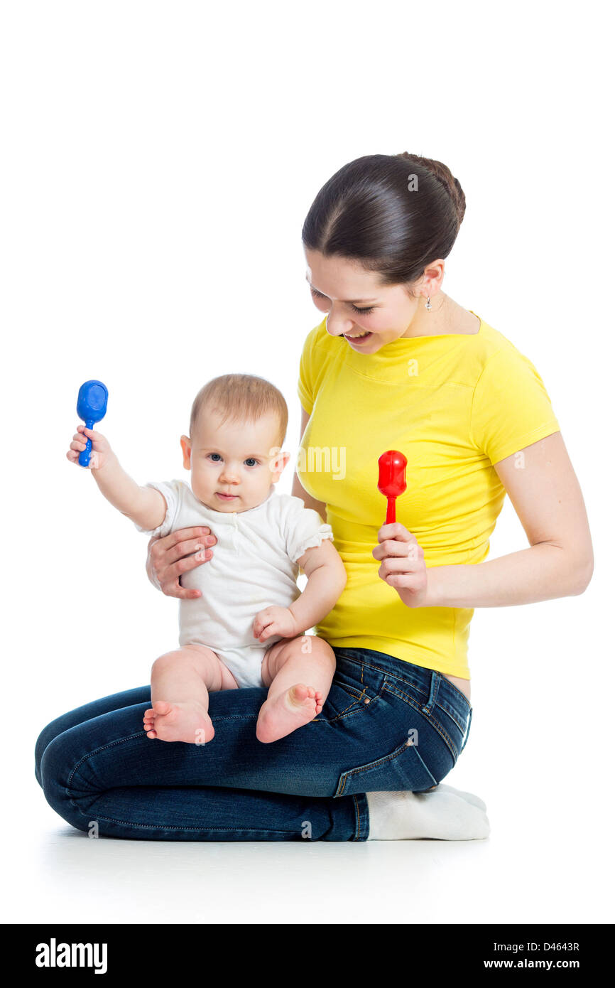 Happy mother and baby girl having fun with musical toy Isolated on white Stock Photo