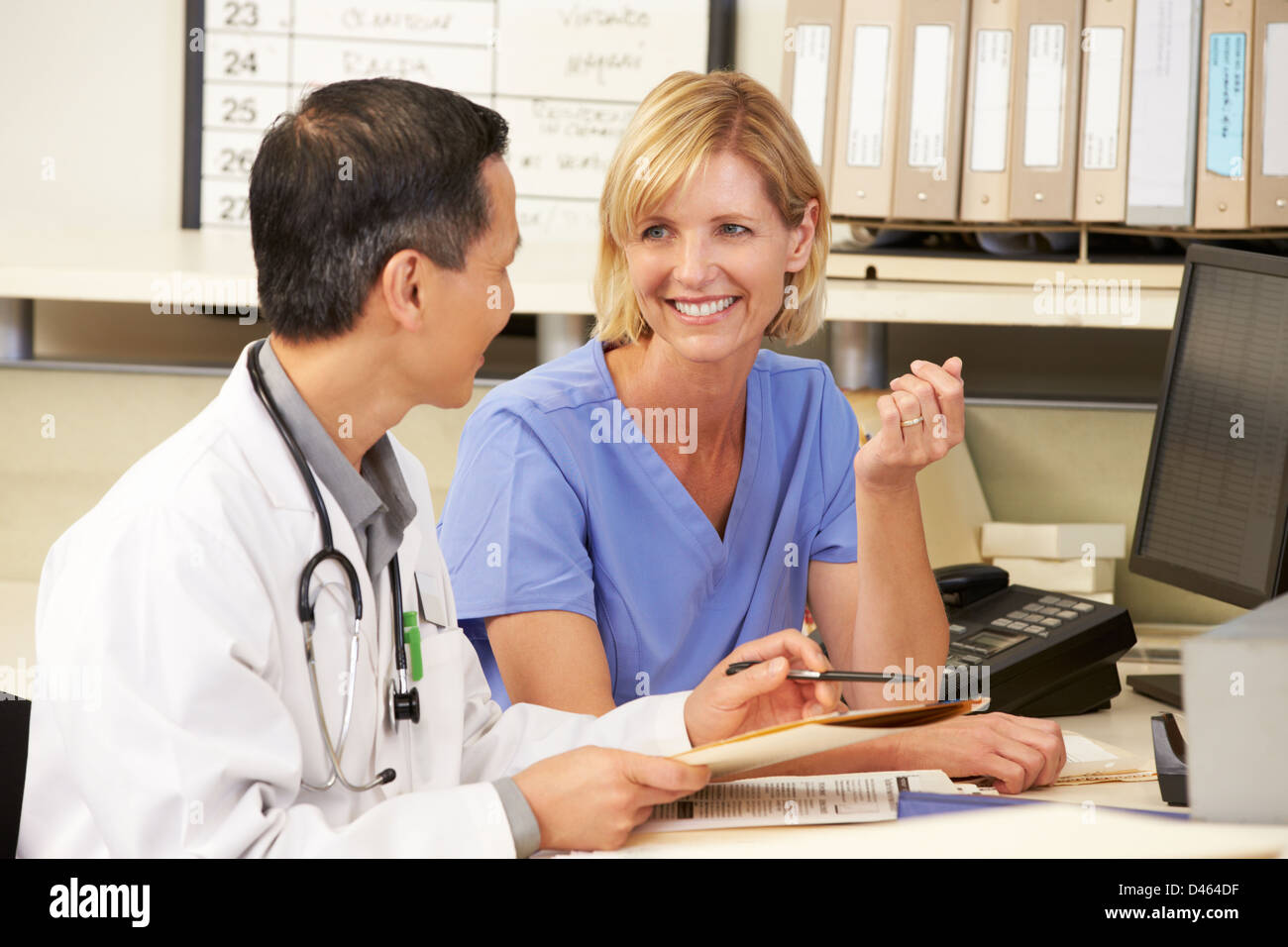 Doctor With Nurse Working At Nurses Station Stock Photo Alamy