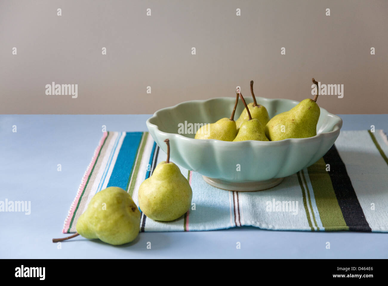 Pears in a scalloped serving dish on a striped placemat Stock Photo Alamy