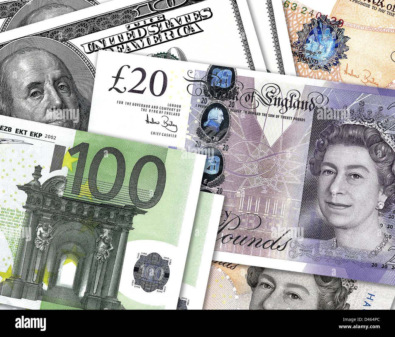 Ten and twenty pound notes overlaping hundred dollar and hundred Euro money. £10, £20, $100 & €100 bills. Stock Photo