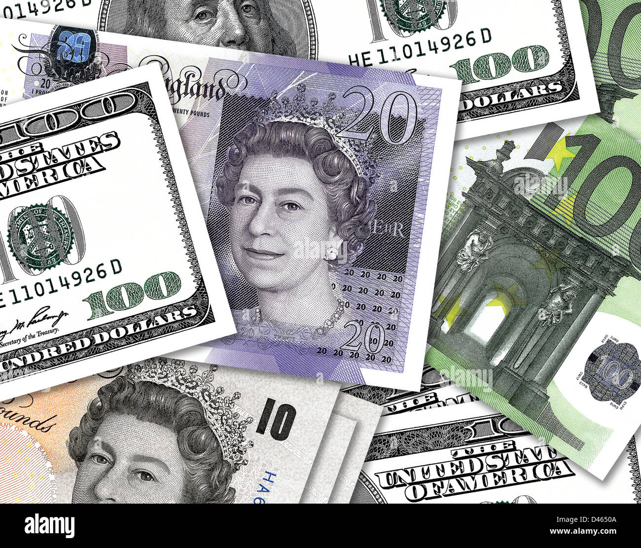 Ten and twenty pound notes overlaping hundred dollar and hundred Euro money. £10, £20, $100 & €100 bills. Stock Photo