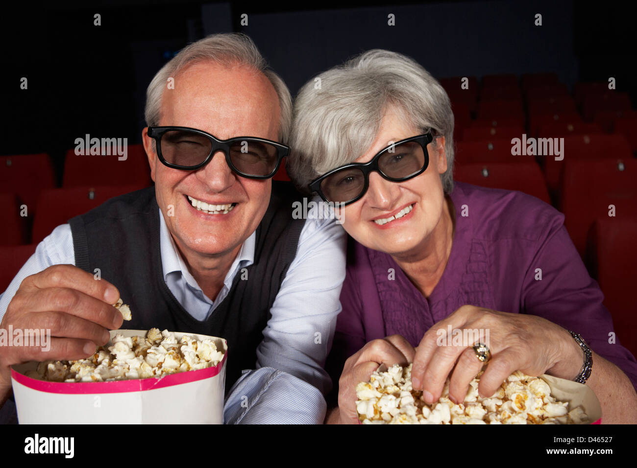 Senior Couple Watching 3D Film In Cinema Stock Photo