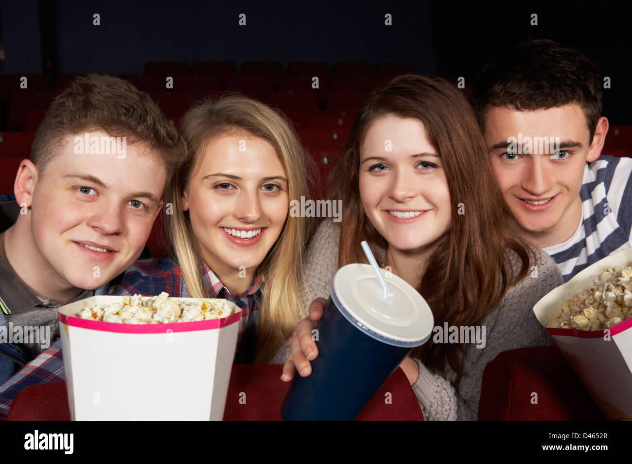 Group Of Teenage Friends Watching Film In Cinema Stock Photo