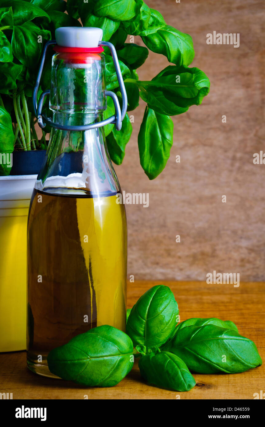 Bottle of olive oil and fresh green basil Stock Photo - Alamy