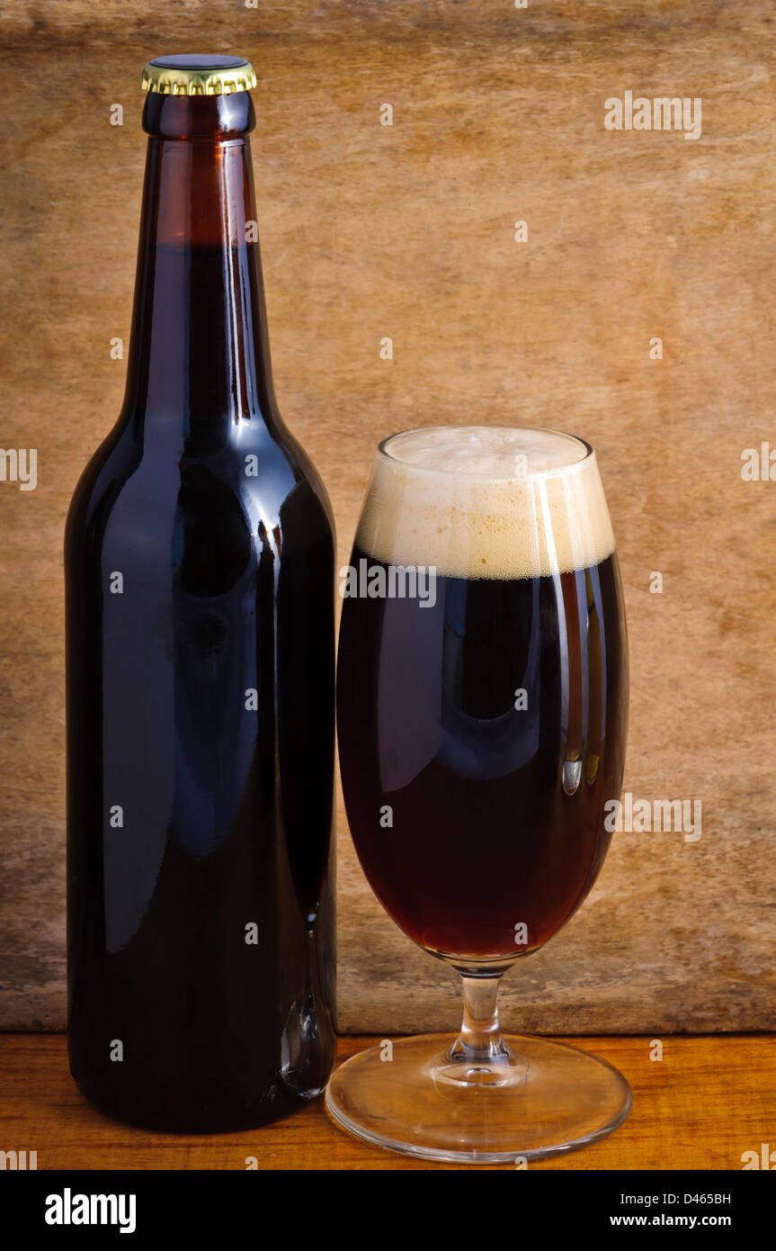 Glass and bottle of dark beer on a wooden background Stock Photo