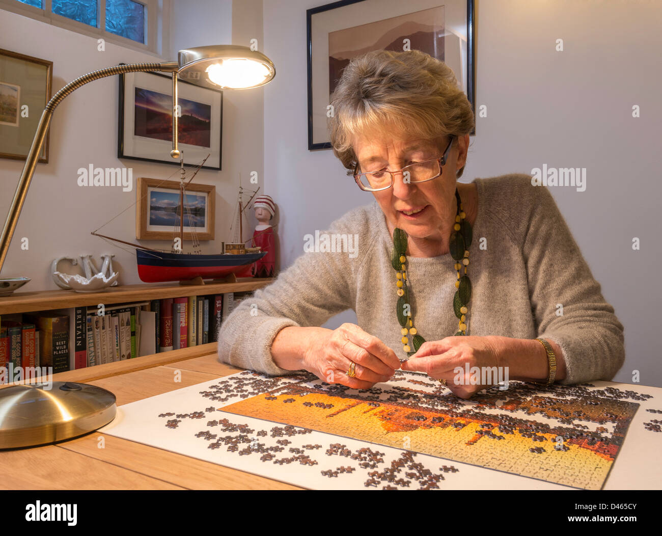 Elderly woman, OAP with jigsaw at home UK Stock Photo