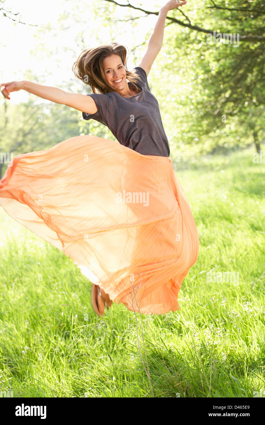 Woman Jumping In Summer Field Stock Photo