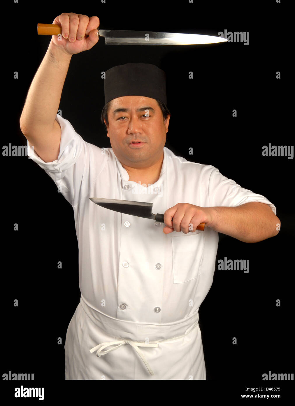 Asian sushi chef posing with his knives Stock Photo