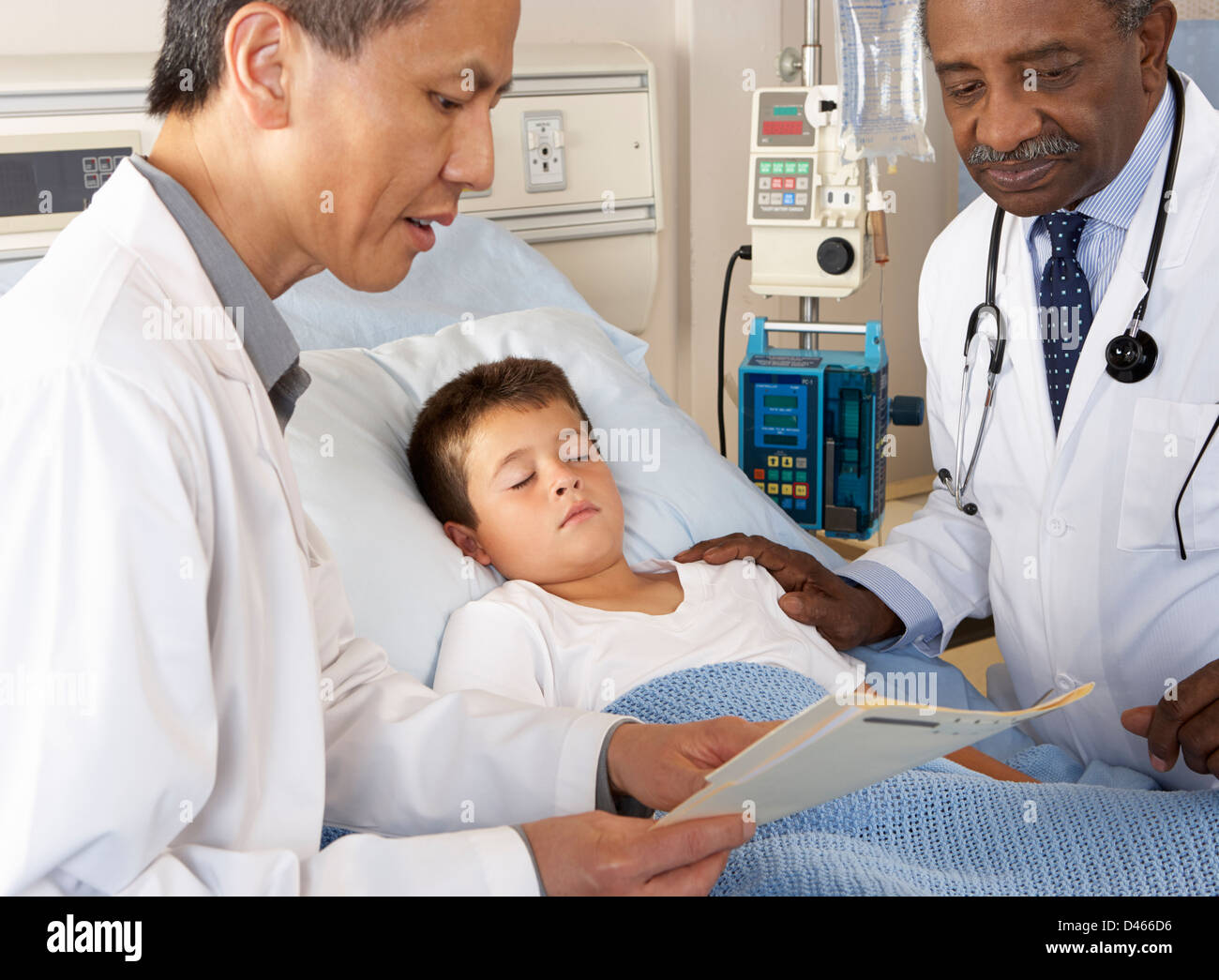 Doctors Visiting Child Patient On Ward Stock Photo Alamy