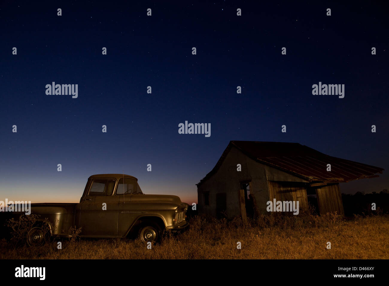 Old Farm Truck and Abandoned House on a farm at night in Texas, USA Stock Photo