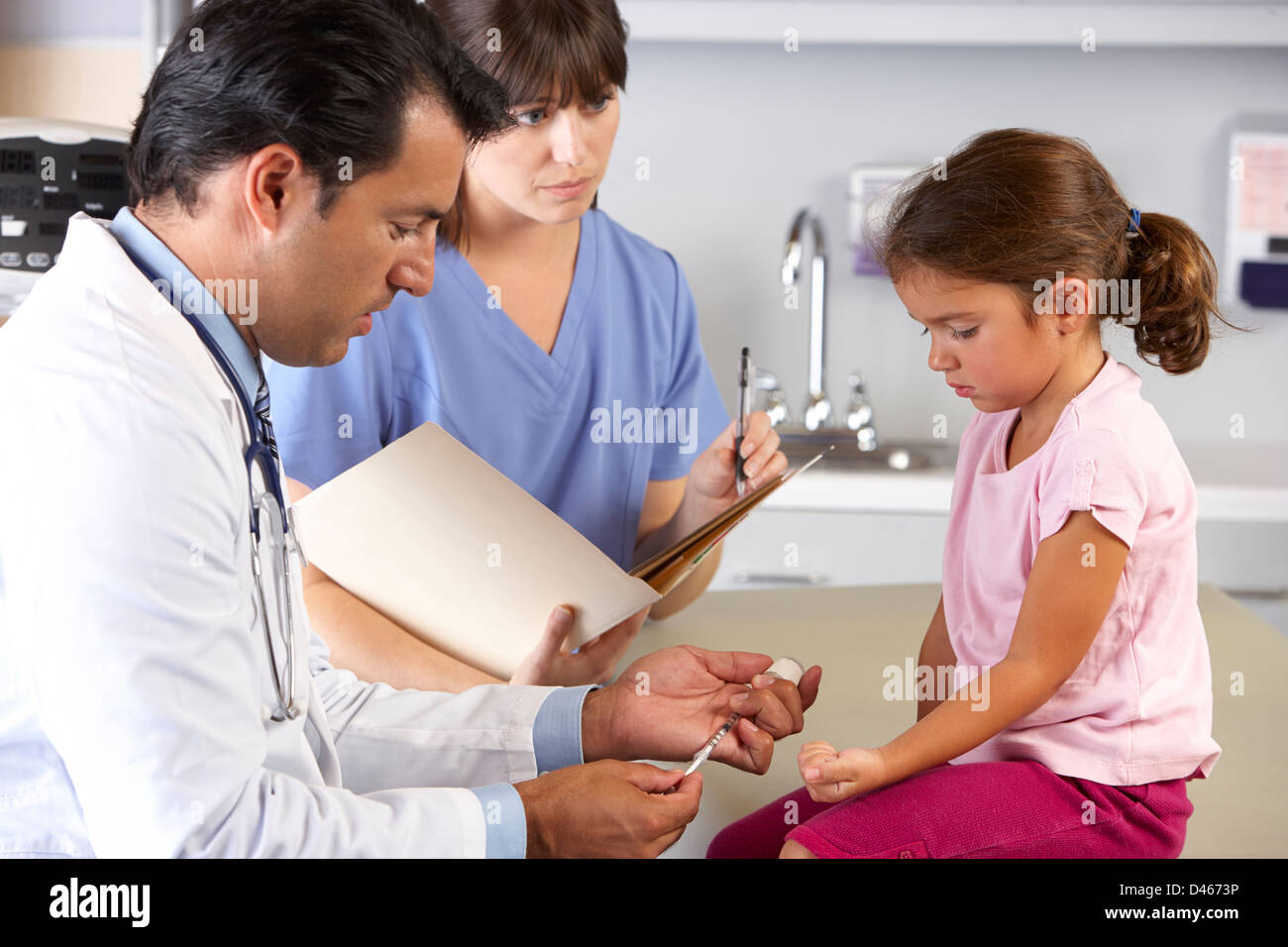 Doctor Giving Child Injection In Doctor's Office Stock Photo