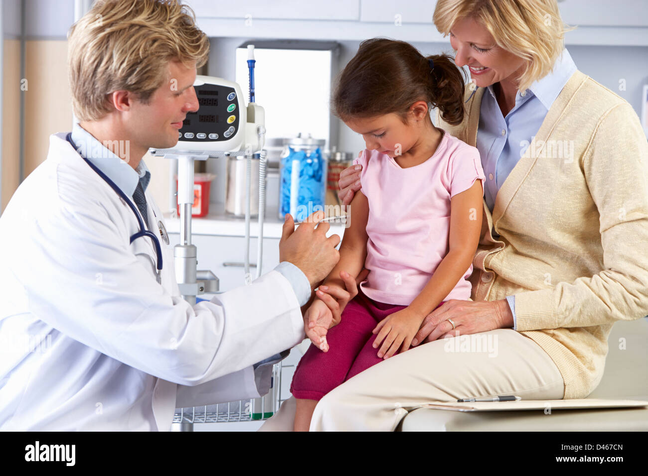 Doctor Giving Child Injection In Doctor's Office Stock Photo