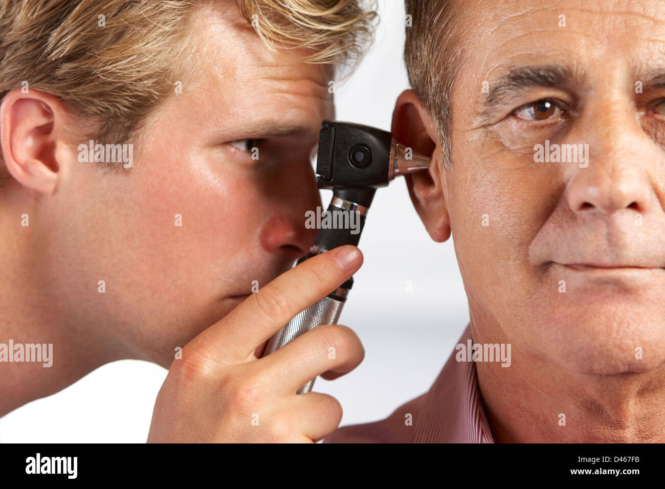 Doctor examining patient ear hi-res stock photography and images - Alamy