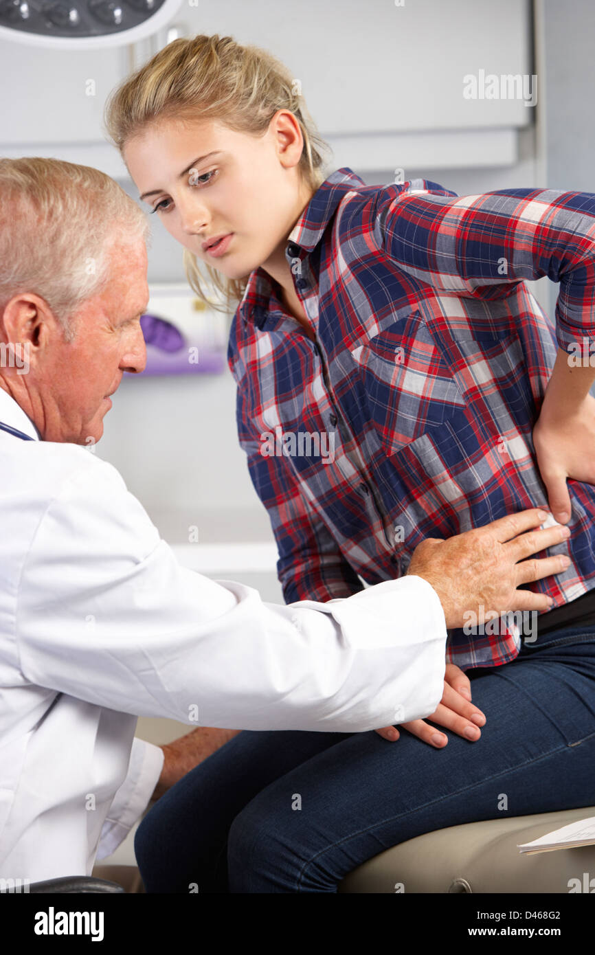 Teenage Girl Visits Doctor's Office With Back Pain Stock Photo
