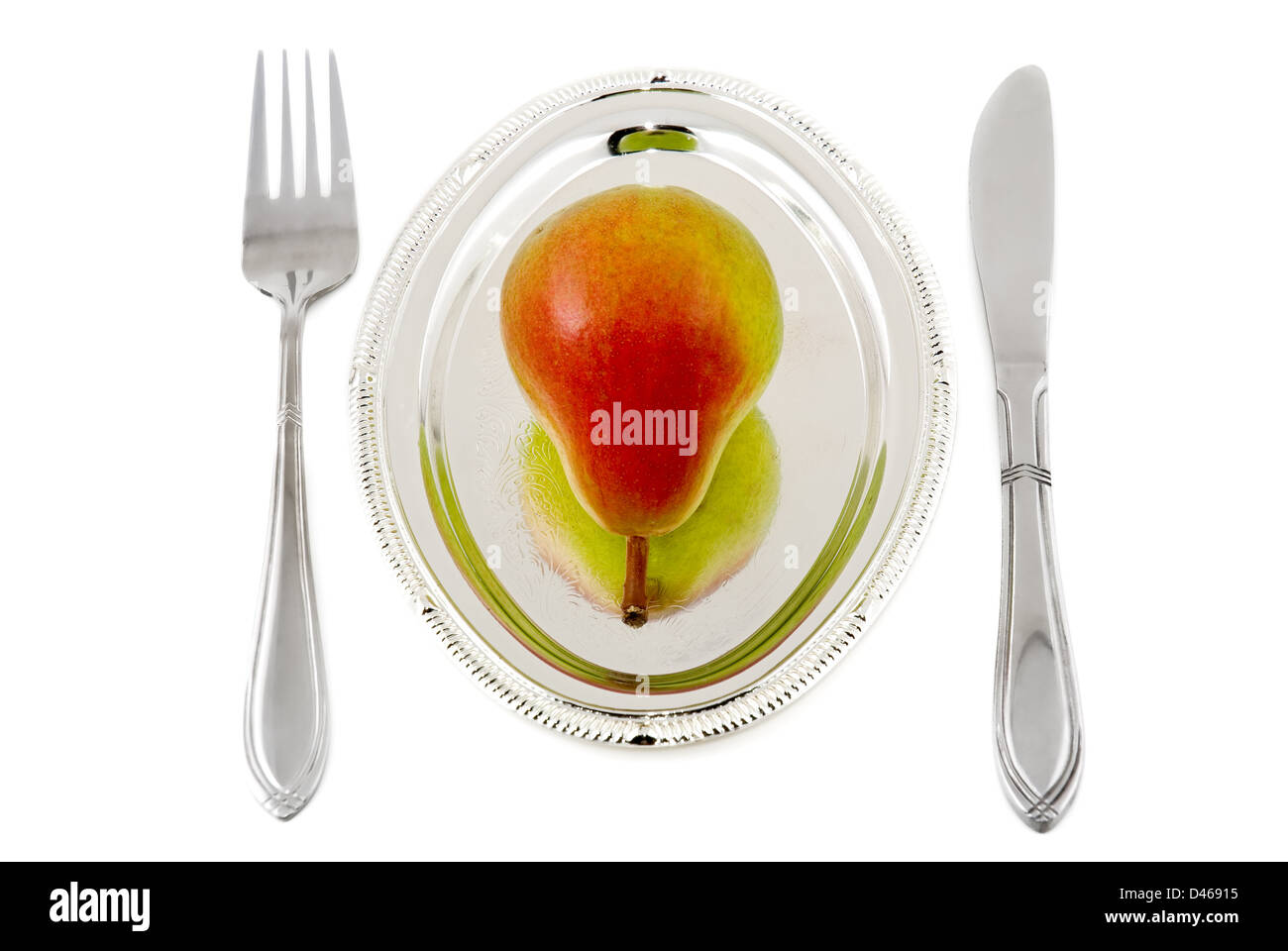 Pear on a silver plate are photographed on the white background Stock Photo