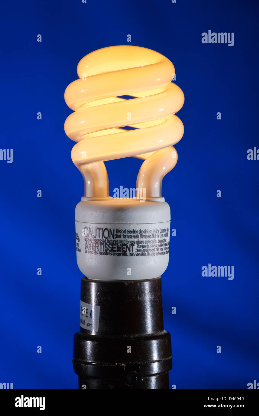 Compact fluorescent energy efficient light bulb with electric power on-Victoria, Vancouver Island, British Columbia, Canada. Stock Photo