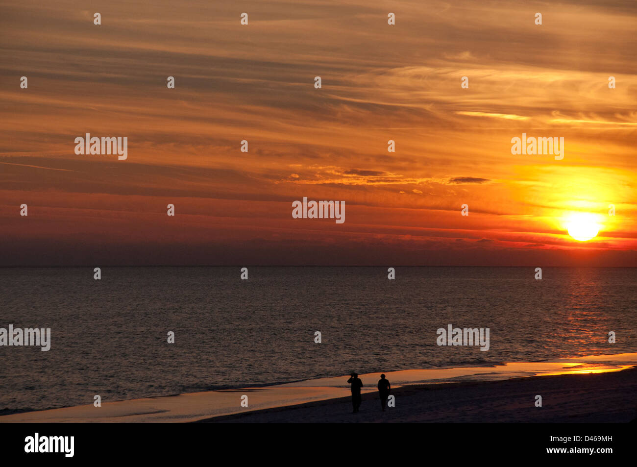 Walking the Okaloosa beach at sunset. Stock Photo