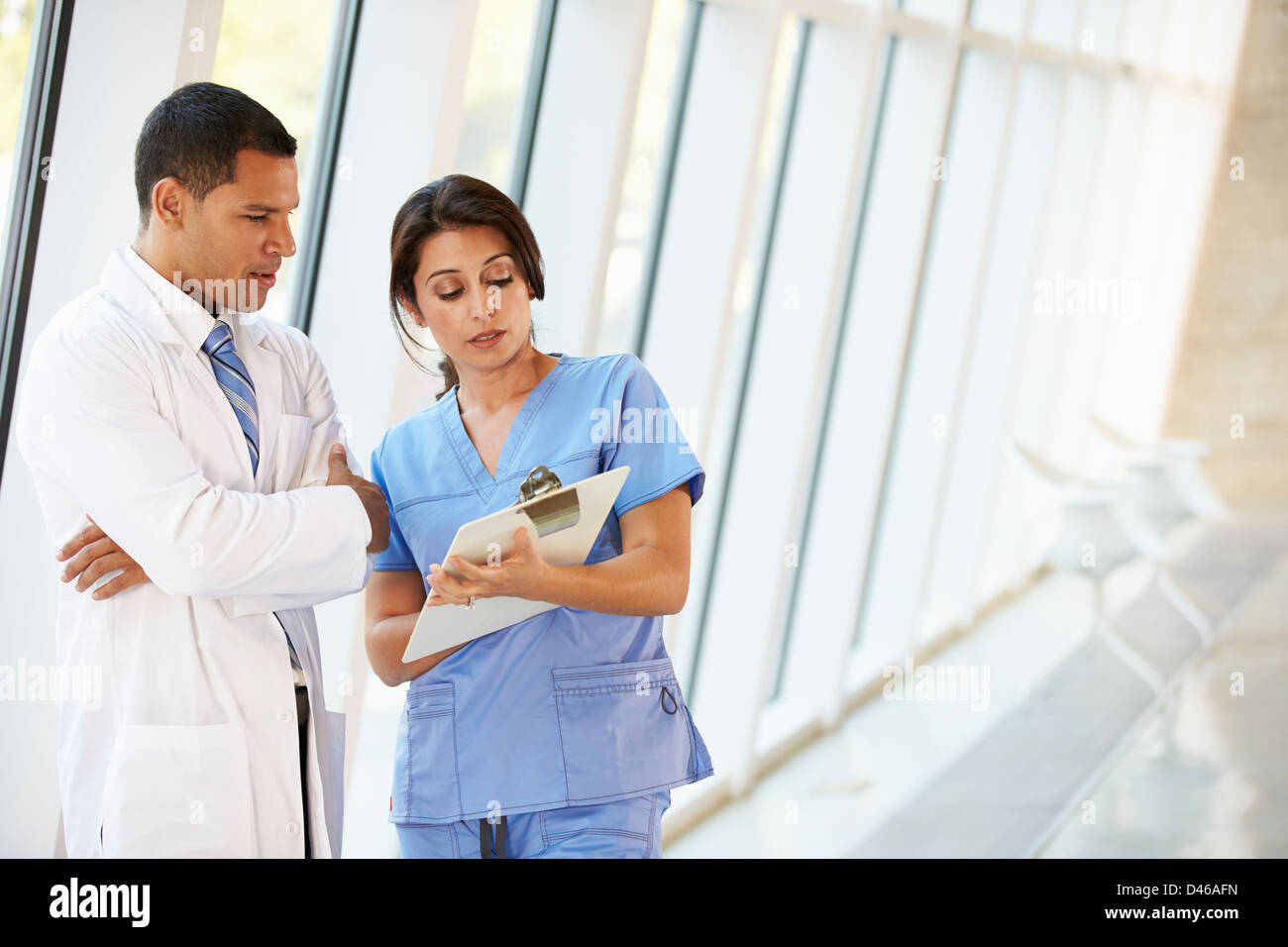 Medical Staff Having Discussion In Modern Hospital Corridor Stock Photo ...