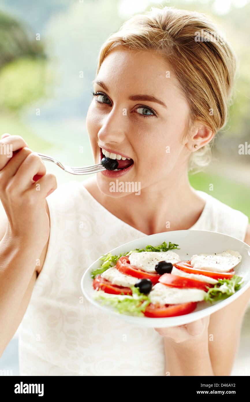 Woman eating healthy salad Stock Photo - Alamy