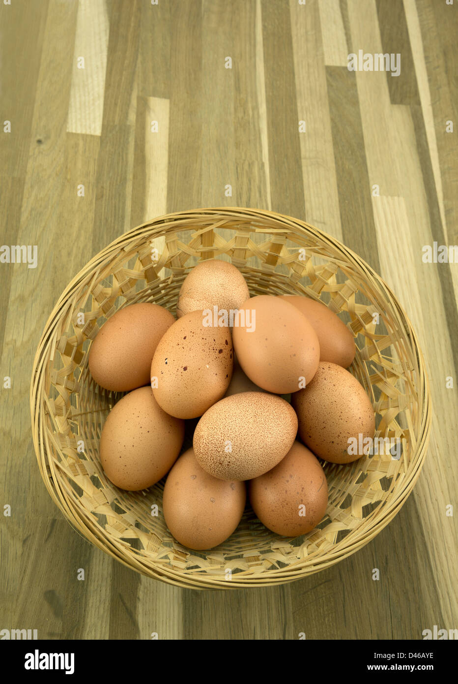 Free range organic eggs in a rustic basket. Stock Photo