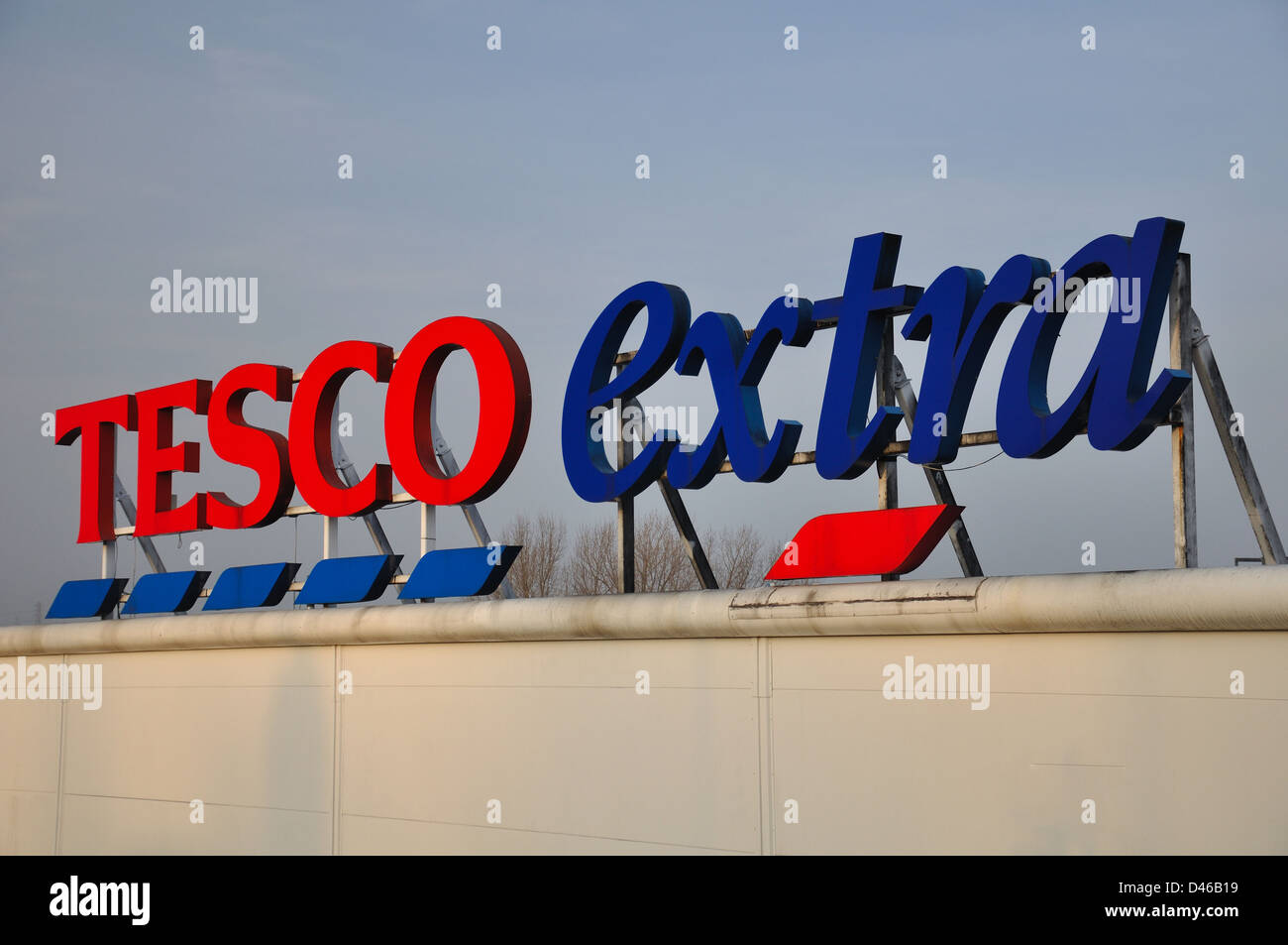 Tesco signs against a blue sky Stock Photo