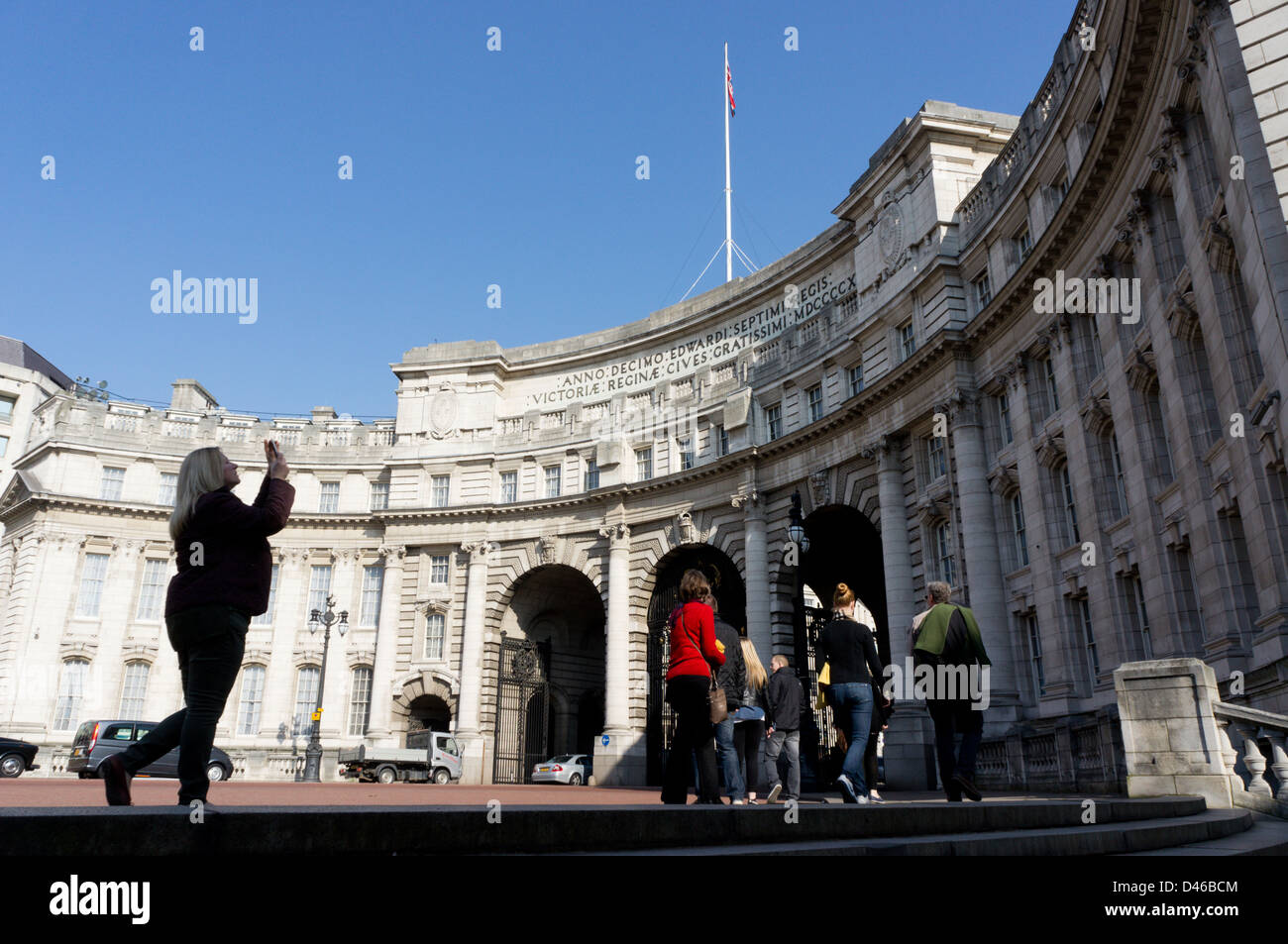 Tourist photographing Admiralty Arch with a mobile 'phone camera, London. Stock Photo