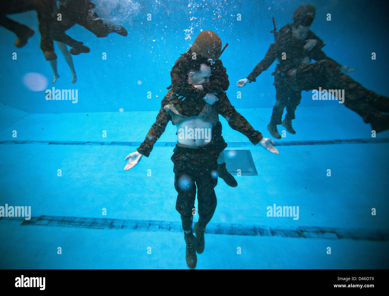 A US Marine is safely recovered underwater as part of a rescue drill during Marine Corps Swim Instructor Course March 5, 2013 at Marine Corps Base Camp Lejeune, NC. Stock Photo