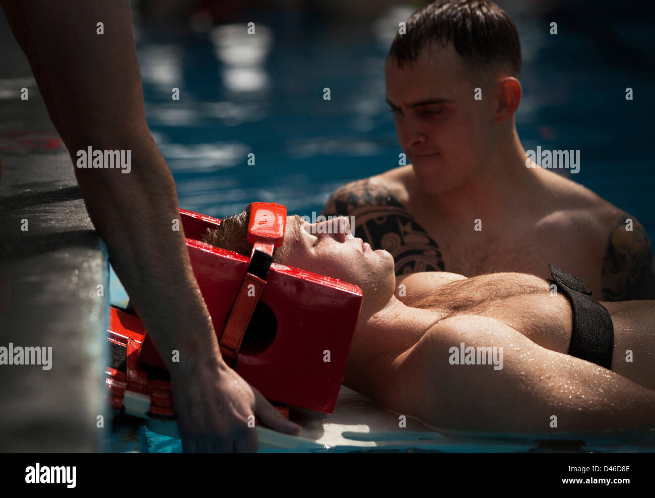 A US Marine instructor demonstrates the proper technique for treating head, neck and spinal injuries in the water during Marine Corps Swim Instructor Course March 5, 2013 at Marine Corps Base Camp Lejeune, NC. Stock Photo