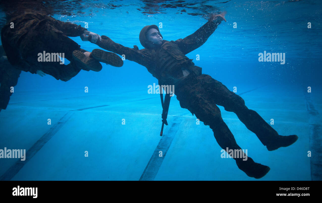 A US Marine is pulled along underwater as part of a rescue drill during Marine Corps Swim Instructor Course March 5, 2013 at Marine Corps Base Camp Lejeune, NC. Stock Photo