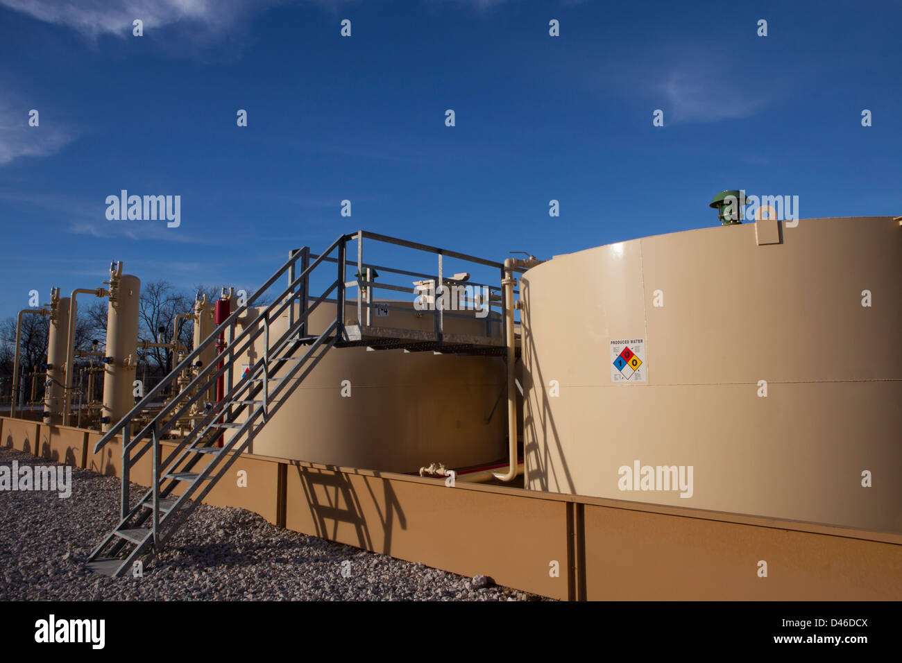 oil and gas wellhead and valves and holding tanks Stock Photo Alamy