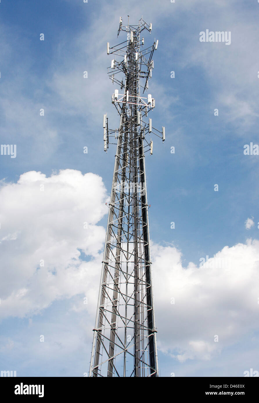 A cell tower in a cloudy blue sky Stock Photo - Alamy