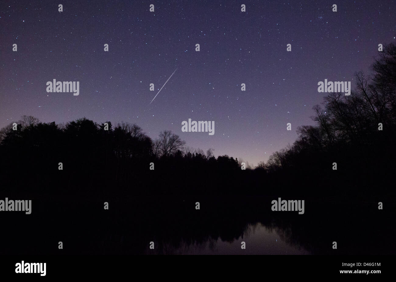 A Geminid Meteor over Lake Norman in North Carolina Stock Photo