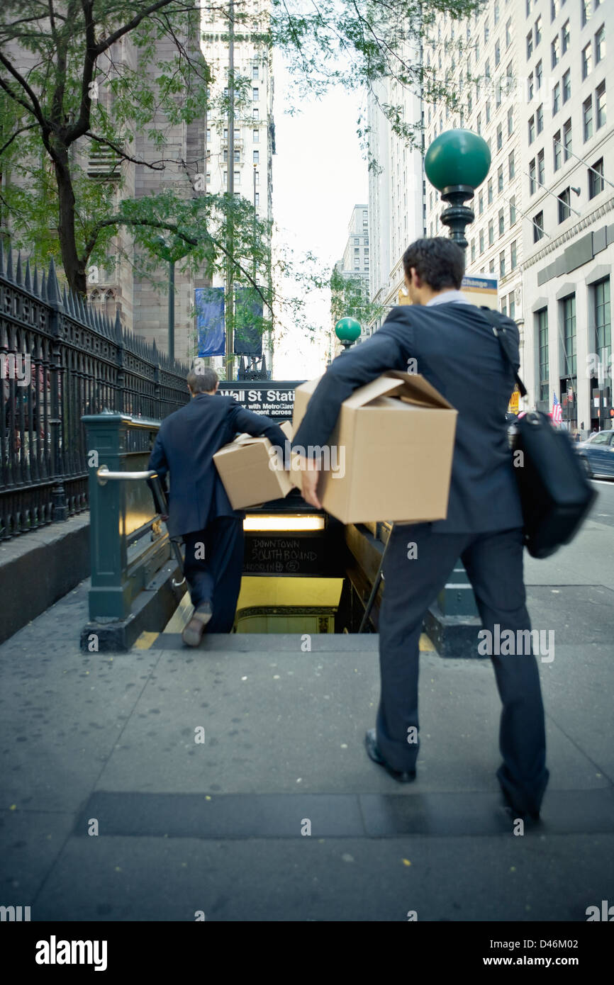 Traders rushing to leave Wall Street after getting the pink slip following market crash. Stock Photo